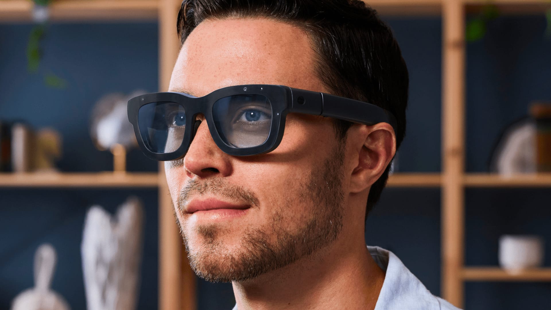 Meta's Orion augmented reality glasses worn in a living room, as publicly announced in 2024